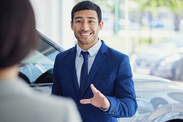 Canvas Print - People, car dealership and salesman with client, pride and confidence for transport, loan or test drive in automobile. Woman, man and excited in showroom for decision in buying new vehicle in shop