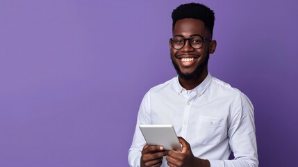 Wall Mural - Full body photo of an African American smiling businessman holding a tablet on a purple background with copy space, real photography