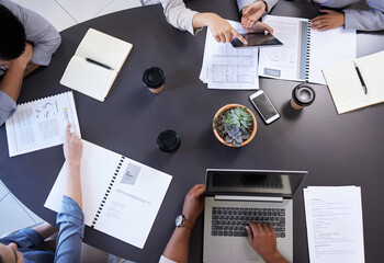 Wall Mural - Business people, above and tech on desk for meeting with feedback discussion, research and documents for project. Staff, brainstorming and workplace conversation for planning strategy and teamwork