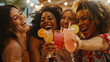 © john - Group of female best friends hugging each other and cheering with drinks