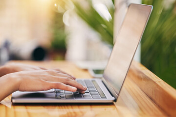 Business person, hands and laptop for website, digital store and commercial blog on wooden table for remote work. Copy writer, research and computer typing for retail tips and online shopping advice