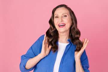 Poster - Photo portrait of lovely senior lady touch curls hair dressed stylish blue garment isolated on pink color background