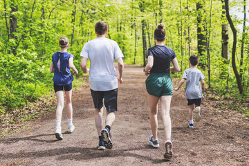 Wall Mural - A Family exercising and jogging together at an outdoor park having great fun