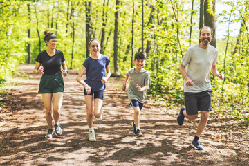 Wall Mural - A Family exercising and jogging together at an outdoor park having great fun