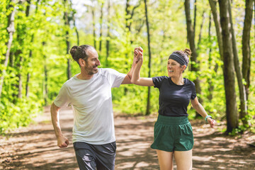 Wall Mural - Couple jogging and running outdoors in nature