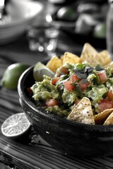 Wall Mural - a bowl of guacamole with chips on a table