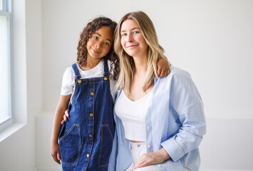 Wall Mural - An Adorable black american little girl with her mother on studio