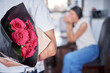 © peopleimages.com - Hope, couple and man with flowers as surprise, anniversary celebration and romance in marriage. Home, married people and husband with red roses, floral and romantic gesture for happy wife with love