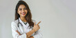 © Ирина Щукина - A woman in a white lab coat is pointing to the sky. Indian doctor, nurse and medical student. College and university
