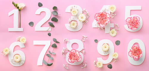 Wall Mural - Numbers and beautiful flowers on pink background, top view. Banner design