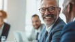 © AI Lab - Cheerful mature businessman attending a meeting with his colleagues in an office Experienced businessman smiling while sitting with his team in a meeting room Creative businesspeople w : Generative AI