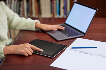 Poster - Library, university and woman on laptop and tablet for online research, studying and learning. Education, college and hands of student on computer and digital tech for knowledge, internet or project