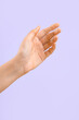 © Pixel-Shot - Woman with dripping honey on her hand against lilac background
