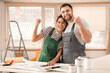 © Pixel-Shot - Beautiful young happy couple planning design of their new house during repair