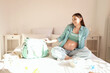 © Pixel-Shot - Young pregnant woman with maternity hospital bag sitting in bedroom