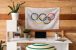 © Pixel-Shot - Modern workplace and Olympic flag on wooden wall in office