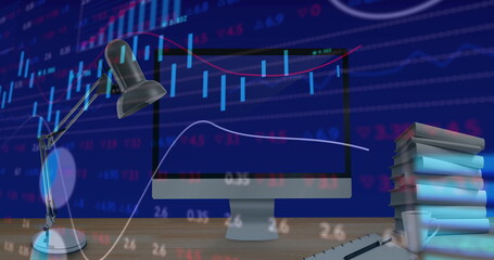 Poster - Desk lamp lighting up computer screen showing stock market charts