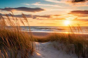 Golden sunset over a sandy beach with tall grass swaying in the breeze, waves gently lapping at the shore, creating a serene and picturesque coastal scene