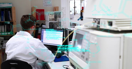Poster - Caucasian male in white lab coat typing on computer in lab