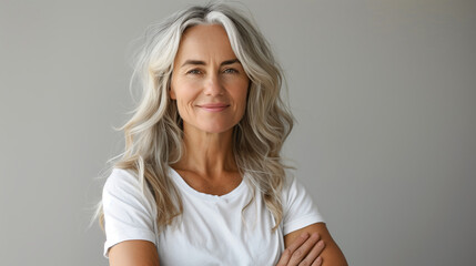 Wall Mural - A smiling middle-aged woman wears a white blank t-shirt, offering ample space for logos or text.
