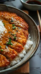 Wall Mural - Delicious rice with golden brown chicken cutlet and creamy curry. The food is served in a bowl with chopsticks.