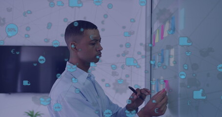 Poster - Image of network of icons over african american man sticking memo notes on board at office