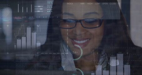 Poster - Image of infographic interface over smiling african american woman working on laptop in office