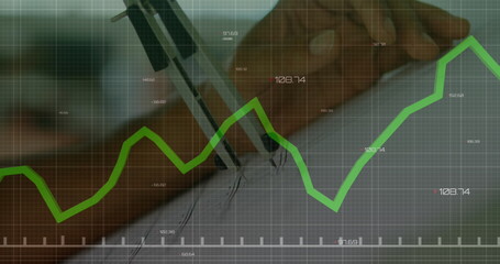 Poster - person holding pen and writing on paper with green financial graph overlay
