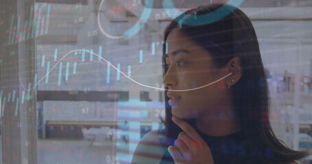 Canvas Print - Image of stock market data processing over biracial woman talking on smartphone at office