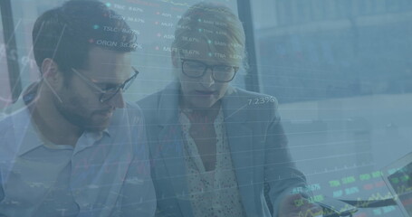 Poster - Image of data processing against diverse businessman and businesswoman discussing over documents