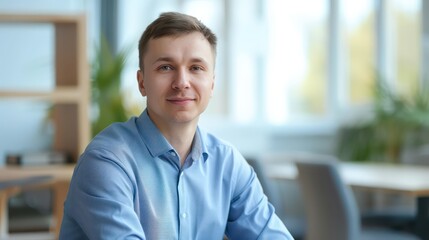 adult confident man in a blue shirt on a background of an office room
