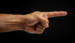© LADALIDI - a man hand with the index finger pointing outward, in black background, direction, instruction, and emphasis.