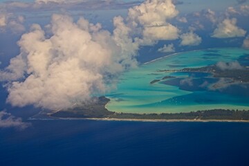 Wall Mural - Departing Bora Bora, a picturesque island group in French Polynesia with a main island surrounded by a a lagoon with striking shades of blue and green