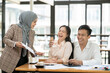 © aekachai - Asian businessmen, women and men Talk about new projects, presents at home office.