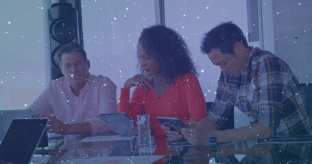 Poster - Image of screens with numbers and graphs over diverse colleagues discussing in office