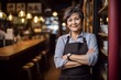 © alisaaa - Proud Cafe Owner invested in a small business after retirement Portrait Of Beautiful Mature Woman Standing In Her Cafe
