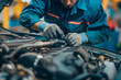 © Татьяна Евдокимова - Skilled automotive technician meticulously examines the engine of a vehicle, performing a diagnostic check in a wellequipped workshop
