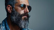 © wasan - Rugged henchman with beard and sunglasses, isolated on gray backdrop
