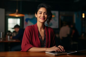 Wall Mural - A Beautiful Smiling Female Teacher Sitting At The Table And Having An Online Class While Looking At Camera A portrait of a happy confident Asian businesswoman holding a pencil and working on her table