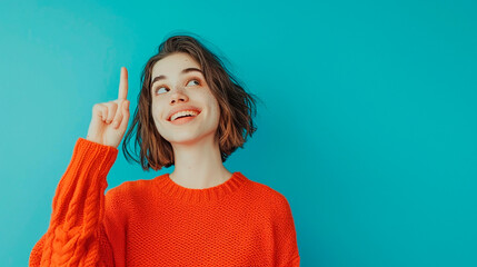 Wall Mural - A woman in a red sweater is pointing her finger up and smiling