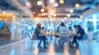 © SH Design - Blurred background of a modern office interior with blurred business people working in a team at a table