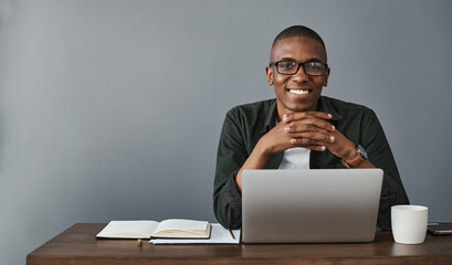 Poster - Happy black man, laptop and portrait in office for software, research and work on wall background in creative startup business. Face, computer and web developer in glasses with mockup space in Kenya