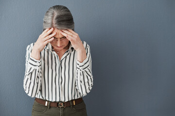 Canvas Print - Mature, woman and headache from stress, anxiety and burnout for mental health isolated in studio. Tired and senior female person or manger with hand on head from exhaustion, fatigue and depression