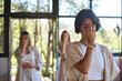© insta_photos - Women group meditating with eyes closed doing yoga pranayama breathing exercises holding fingers on face feeling energy during holistic healing yoga training class retreat session.