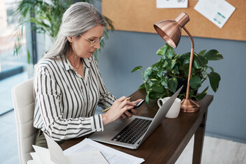 Leinwandbilder - Smartphone, laptop and mature business woman reading email, networking and scroll on app in startup. Phone, computer and manager research information on website for creative work project of editor