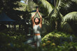 © insta_photos - Fit sporty mindful young Hispanic woman meditating doing yoga breathing exercises with eyes closed feeling peace of mind, mental balance standing in green nature tropical park on sunny day.
