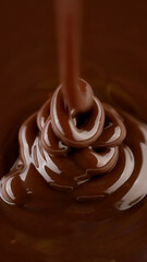 Wall Mural - Pouring melted dark chocolate, close up. Liquid hot chocolate. Confectioner prepares chocolate dessert, glaze