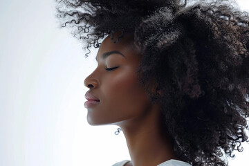 Wall Mural - Close up head portrait of black young beautiful woman with curly afro hair isolated on light background with space for text or inscriptions
