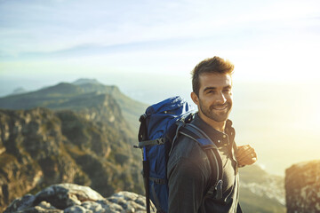 Poster - Portrait, sunshine and hiking with man, fitness and journey with nature, smile and getaway trip. Wellness, person and hiker with backpack, adventure and vacation with happiness, holiday and mountains