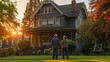 © Maria Shchipakina - A senior couple in a warm embrace look towards their recently bought home at sunset.